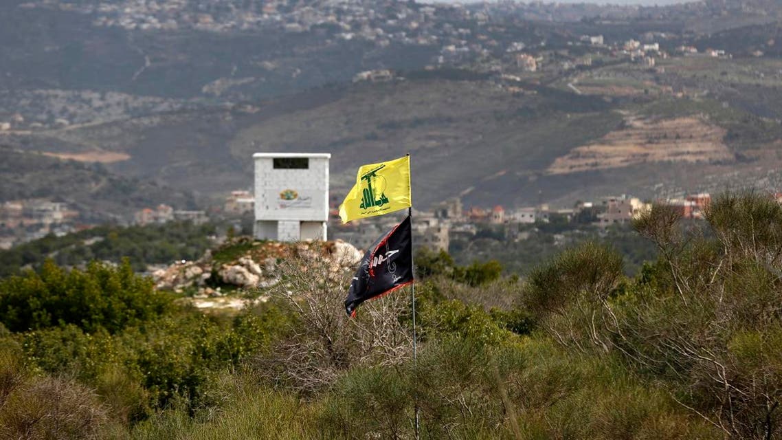 A picture taken from the Israeli side of the border shows the flag of Lebanon's Hezbollah Shiite movement and a religious flag reading "al-Hussein", in the southern Lebanese village of Aita al-Shaab on February 8 2018.