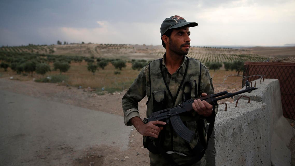 A Syrian security officer mans a checkpoint on the outskirts of Jarablus, northern Syria, on May 30, 2018. (AP)