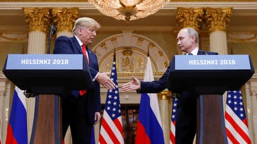 FILE PHOTO: U.S. President Donald Trump and Russia's President Vladimir Putin shake hands during a joint news conference after their meeting in Helsinki, Finland, July 16, 2018. REUTERS/Kevin Lamarque/File Photo