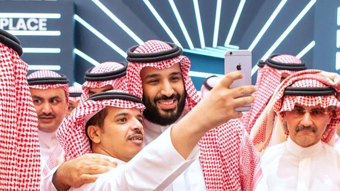 A handout picture provided by the Saudi Royal Palace on October 23, 2018 shows Saudi Crown Prince Mohammed bin Salman (L) posing for a selfie. (AFP)