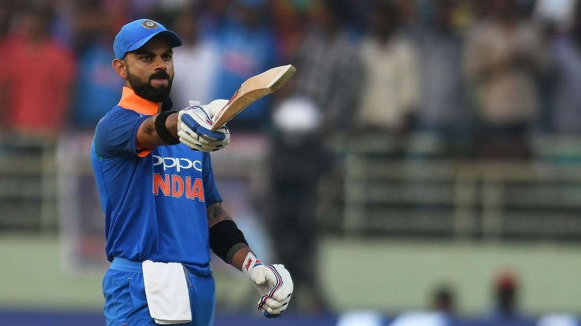 Indian cricket captain Virat Kohli raises his bat after scoring century (100 runs) during the second one day international (ODI) cricket match between India and West Indies at the Dr. Y.S. Rajasekhara Reddy ACA-VDCA Cricket Stadium in Visakhapatnam on October 24, 2018. NOAH SEELAM / AFP