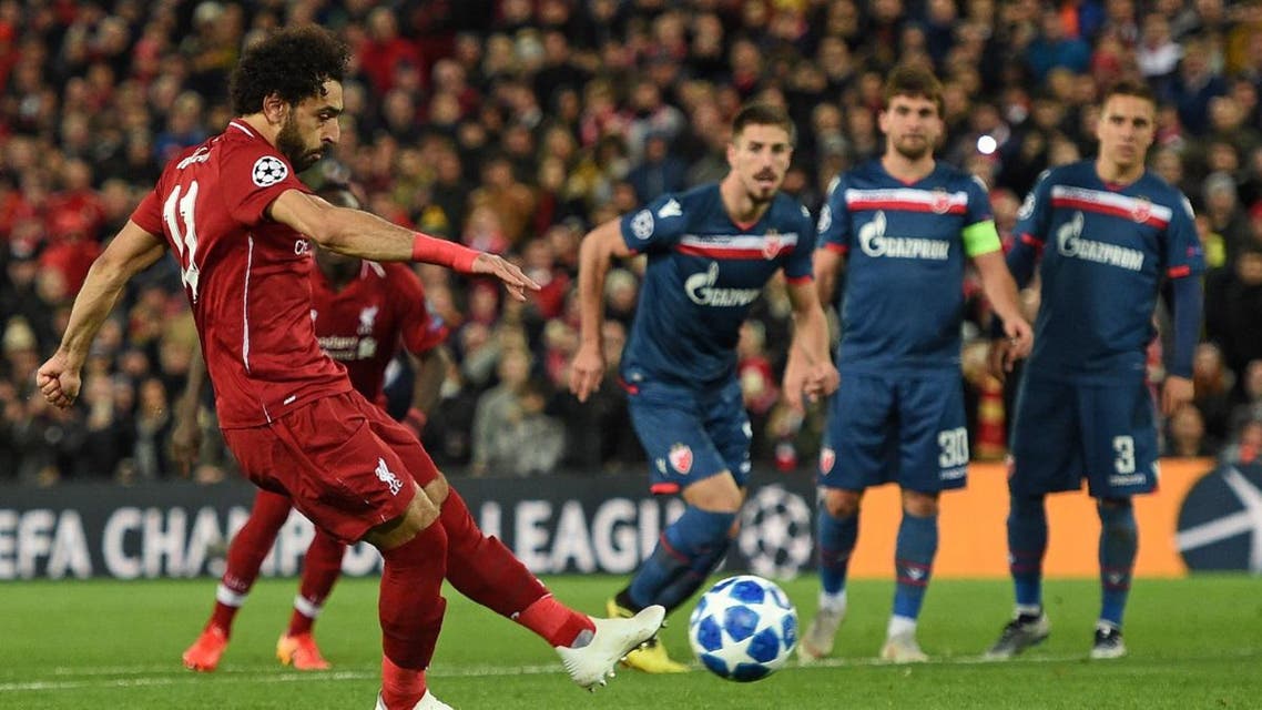 Liverpool's Egyptian midfielder Mohamed Salah (L) scores their third goal from the penalty spot during the UEFA Champions League group C football match between Liverpool and Red Star Belgrade at Anfield in Liverpool, north west England on October 24, 2018. (AFP)