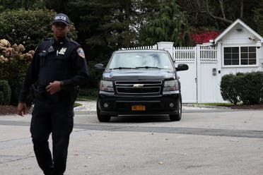 Law enforcement stands outside the gatehouse of Bill and Hillary Clinton's house in Chappaqua. (Reuters)