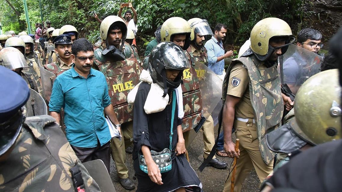 Indian activist Rehana Fatima (C) walks with police wearing protective gear near the Lord Ayyappa temple complex at Sabarimala in India's southern Kerala state on October 19, 2018. (AFP)