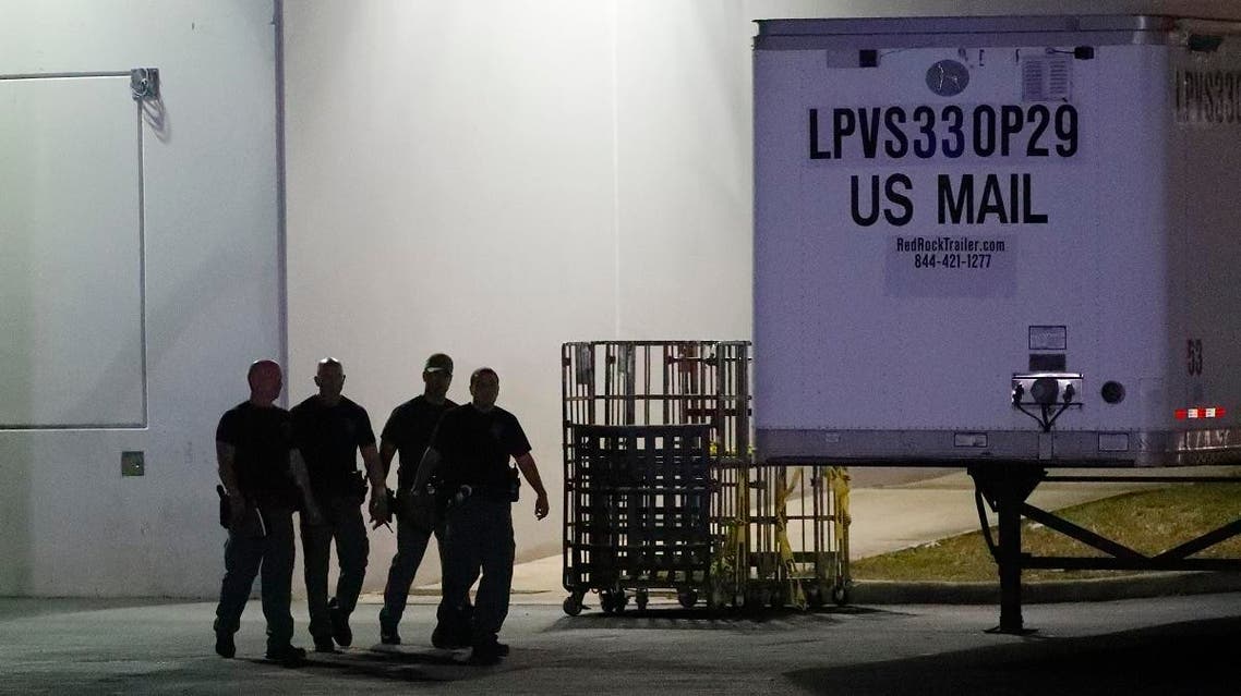 Members of the Miami-Dade County Bomb Squad walk outside a postal facility, on Thursday, in Opa-locka, Florida. (AP)