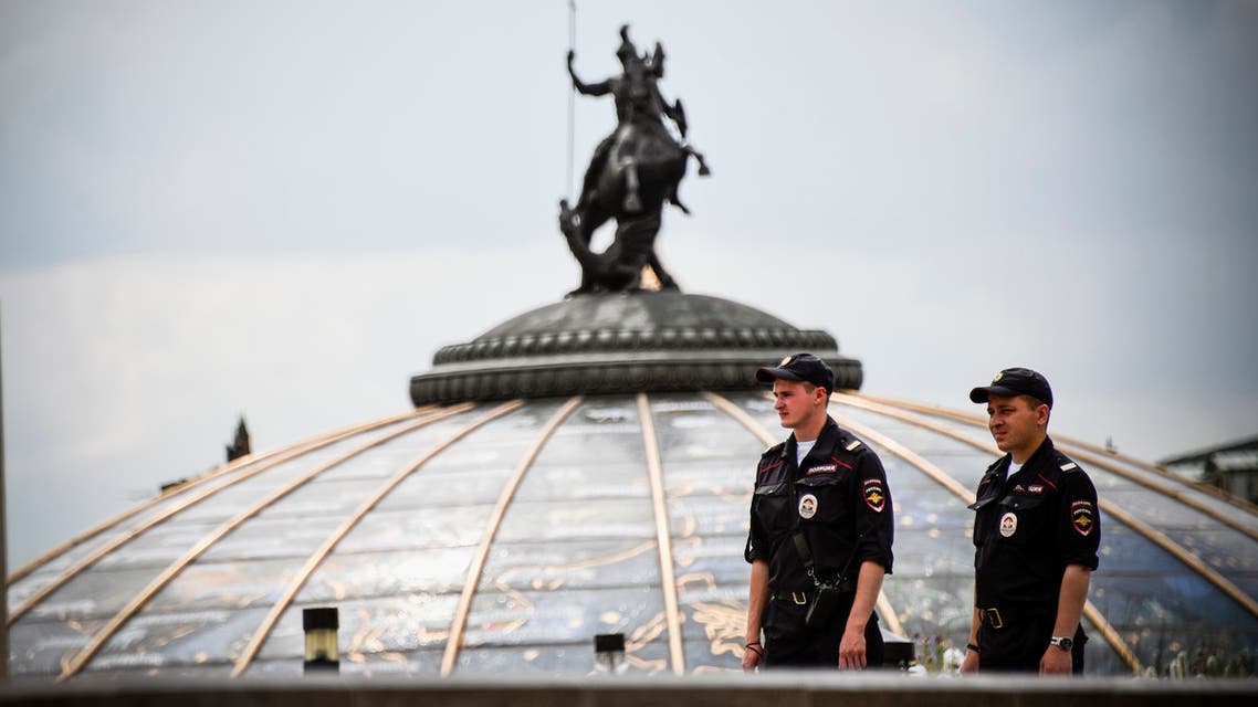 Russian police officers stand guard on Manezhnaya Square in downtown Moscow on July 13, 2018, two days before the Russia 2018 World Cup final football match between France and Croatia.
