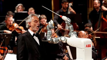Humanoid robot YuMi conducts the Lucca Philharmonic Orchestra performing a concert alongside Italian tenor Andrea Bocelli at the Verdi Theatre in Pisa, Italy September 12, 2017. (Reuters)
