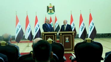 Iraq's Prime Minister-designate Adel Abdul Mahdi speaks with former Prime Minister Haidar al-Abadi during the office handover ceremony in Baghdad, Iraq, October 25, 2018. (Reuters)