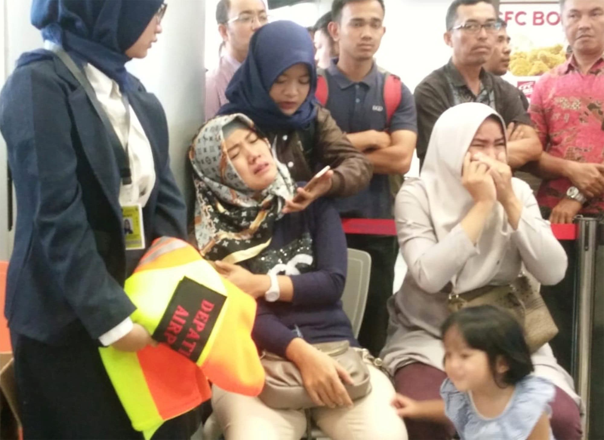 Relatives of passengers of Lion Air flight JT610 that crashed into the sea, cry at Depati Amir airport in Pangkal Pinang. (Reuters)