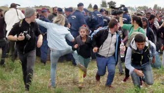 Hungarian camerawoman who tripped, kicked fleeing migrants gets acquitted 