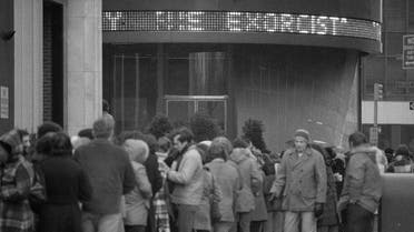 Despite sub-freezing temperatures and rain, a crowd waits in line outside the Paramount Theater in New York City February 4, 1974 for a showing of "The Exorcist." (AP)a