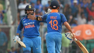 Indian batsman Rohit Sharma and captain Virat Kohli (R) celebrate their team’s victory during the fifth ODI match against and West Indies in Thiruvananthapuram on November 1, 2018. (AFP)