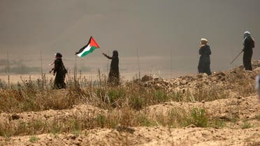 A Palestinian women waves her national flag (AFP)