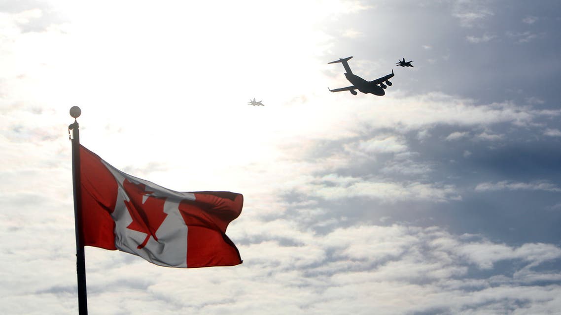 The plane carrying the last of Canada's troops in Afghanistan is escorted through the air by fighter jets, after the last Canadian troops from Afghanistan returned to Ottawa International Airport on March 18, 2014 in Ottawa, Ontario. Eighty-four armed forces members were welcomed home marking the end of Canada's participation in the Afghanistan war, a mission that spanned 12 years. AFP PHOTO/ Cole Burston