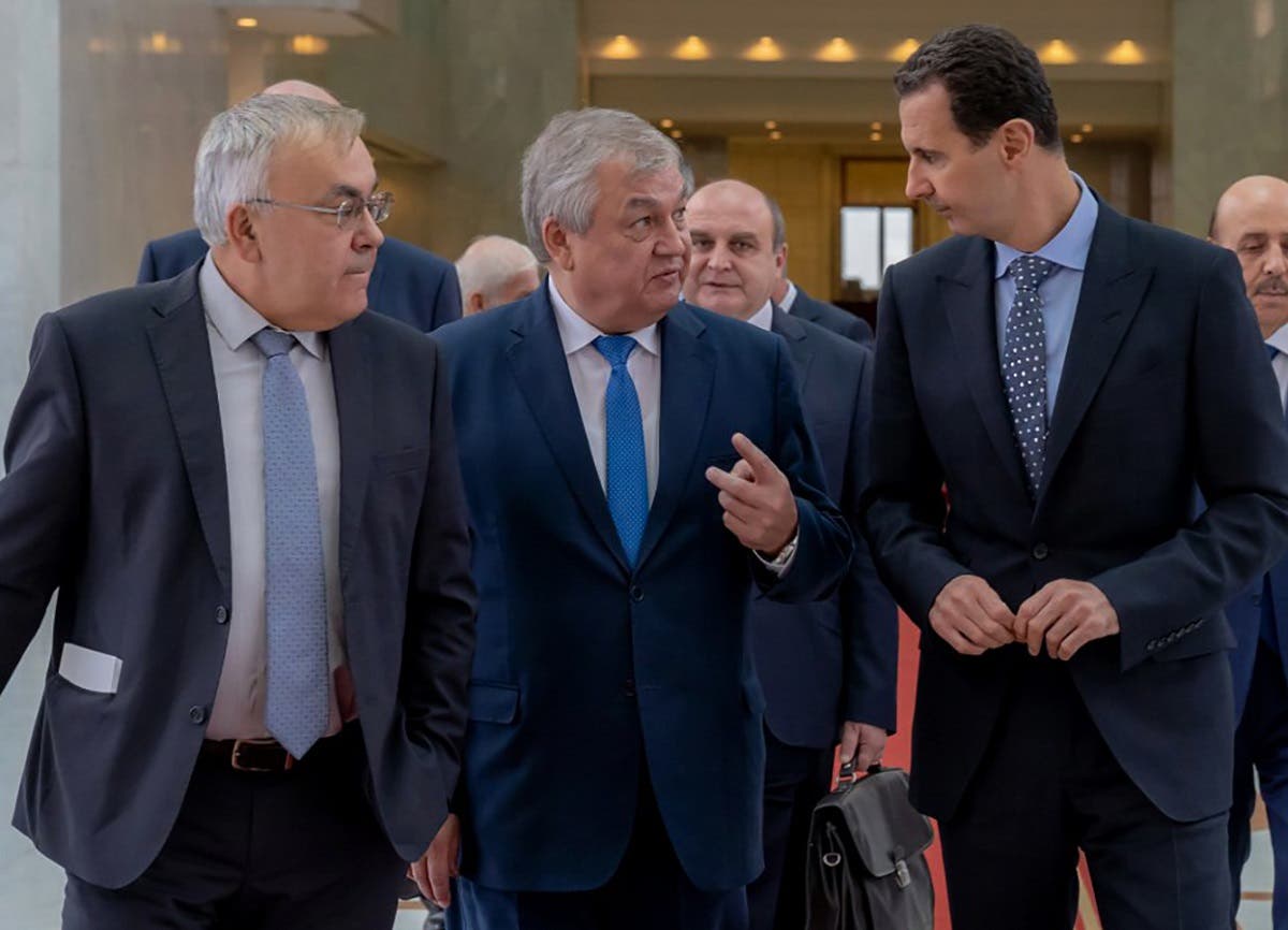 Syrian President Basah al-Assad (R) receiving Russian special envoy to Syria Alexander Lavrentiev (C) (AFP)