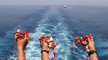 Families and colleagues of passengers and crew of Lion Air flight JT610 throw flowers and petals from the deck of Indonesia Navy ship KRI Banjarmasin as they visit the site of the crash to pay their tribute, at the north coast of Karawang. (Reuters)