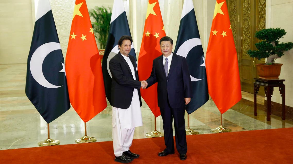 China’s President Xi Jinping (R) shakes hands with Pakistan’s Prime Minister Imran Khan (L) at the Great Hall of the People in Beijing on November 2, 2018. (AFP)