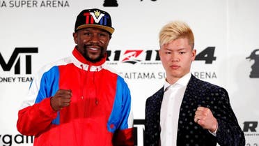Boxer Floyd Mayweather Jr. of the U.S. poses for a photograph with his opponent Tenshin Nasukawa during a news conference in Tokyo. (Reuters)
