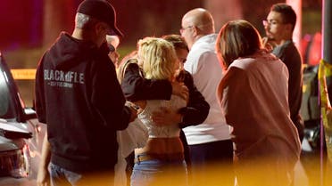 People comfort each other as they stand near the scene Thursday, on November 8, 2018, in Thousand Oaks, California, where a gunman opened fire Wednesday inside a country dance bar. (AP)