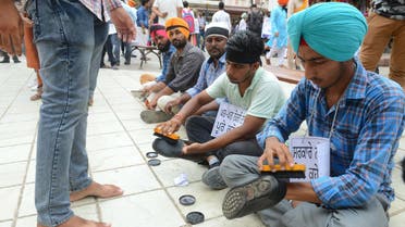 Members of an elementary teachers union polish shoes during a protest against government to demand jobs in Amritsar on August 8, 2018. (AFP)
