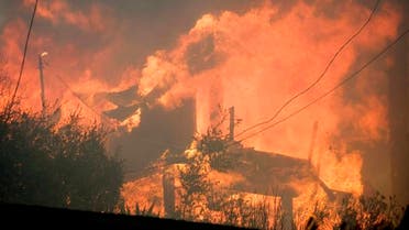 A wildfire burns a structure near Malibu Lake in Malibu, Calif., Friday, Nov. 9, 2018. (AP)