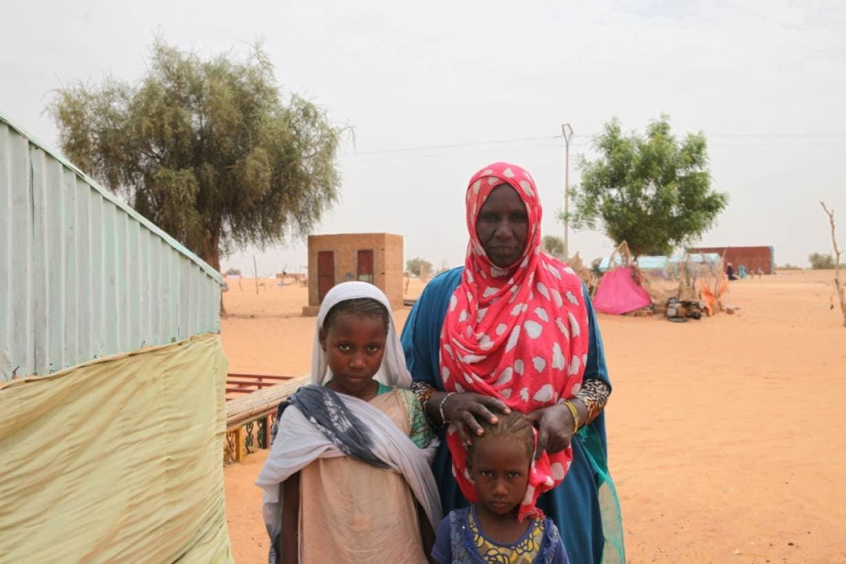 Aminetou Mint Yarg poses with family members in the commune of Dar El Barka, Mauritania, October 20, 2018. (Thomson Reuters Foundation/Nellie Peyton)