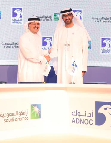 Sultan Ahmed al-Jaber (R), the director general and CEO of the Abu Dhabi National Oil Company (ADNOC), shakes hands with Saudi Aramco CEO Amin Nasser after signing a cooperation deal in Abu Dhabi on November 12, 2018.  (AFP)