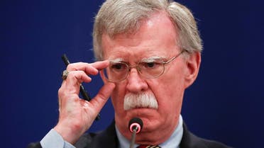 US National Security Adviser John Bolton adjusts glasses during a news briefing. (Reuters)
