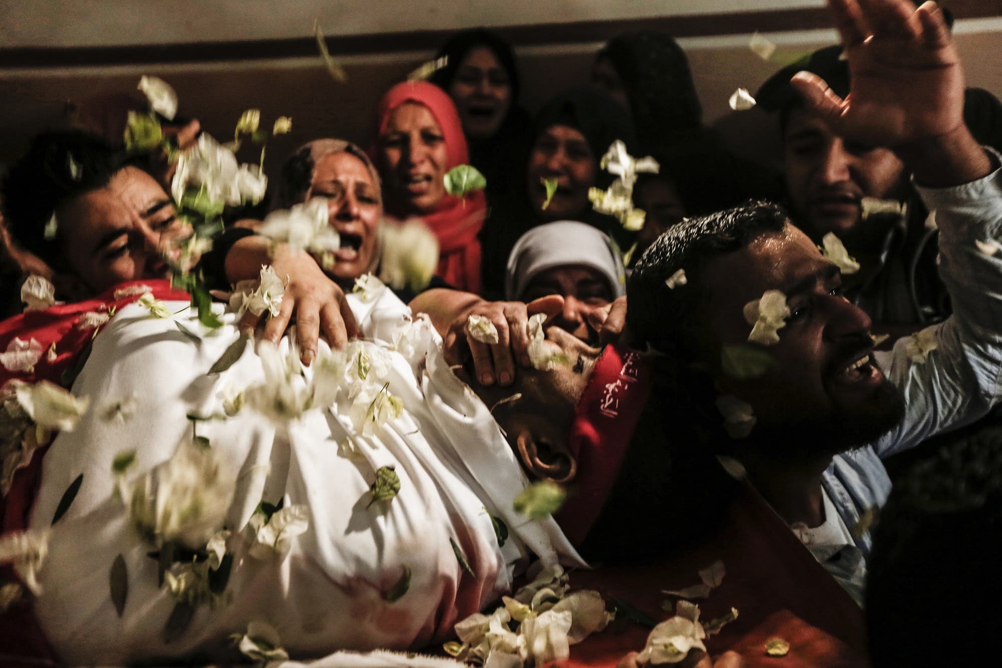Relatives of Mohammed Ouda, killed in an Israeli air stike the previous day, mourn during his funeral in Beit Lahia in the northern Gaza Strip on November 13, 2018. (AFP)