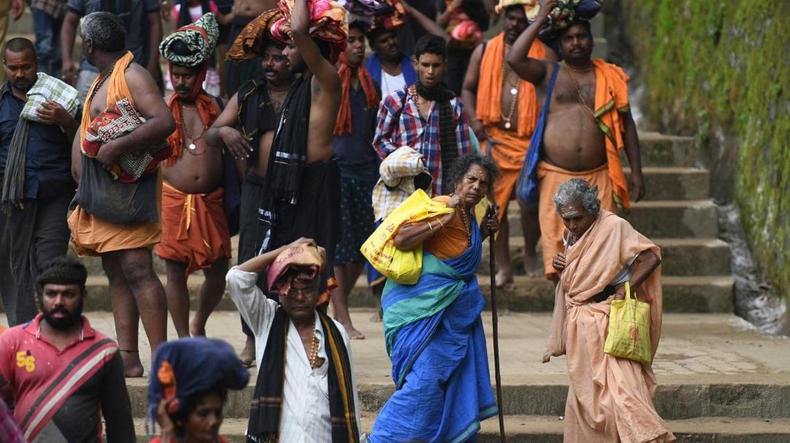 This photo taken on November 18, 2018 shows elderly Hindu women trekking to the Sabarimala temple in the southern state of Kerala. Tens of thousands of pilgrims have thronged to the hilltop shrine ahead of a Supreme Court ruling November 19 on whether it should be given more time to let women enter. (AFP)