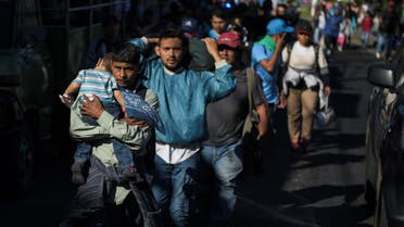 Salvadoran migrants begin their journey in caravan heading the United States, in San Salvador, on November 18, 2018. The migrants are mostly fleeing poverty and unrest in Central America's "Northern Triangle" -- El Salvador, Guatemala and Honduras, where brutal gang violence has fuelled some of the highest murder rates in the world.