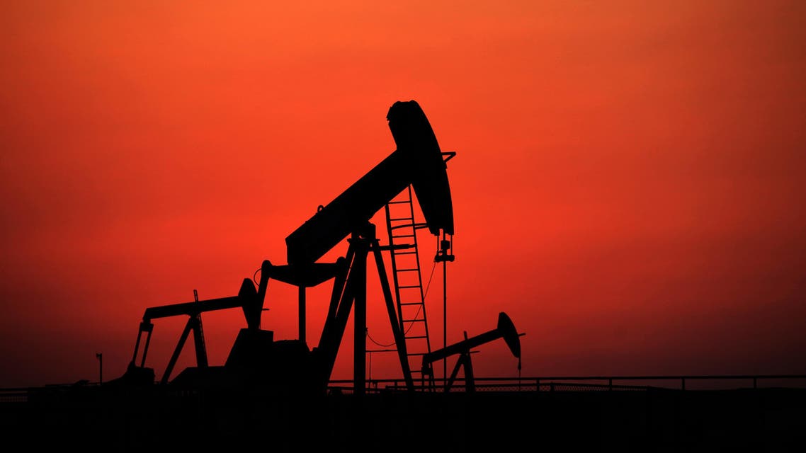 Oil pumps work at sunset on Wednesday, Sept. 11, 2013, in the desert oil fields of Sakhir, Bahrain. (AP)