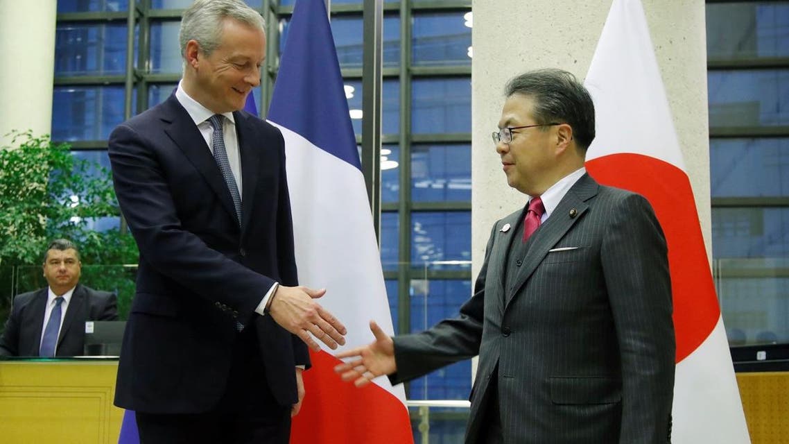 French Finance Minister Bruno Le Maire shakes hands with Japan’s Minister of Economy, Trade and Industry Hiroshige Seko after a meeting around Renault-Nissan in Paris on November 22, 2018. (Reuters)