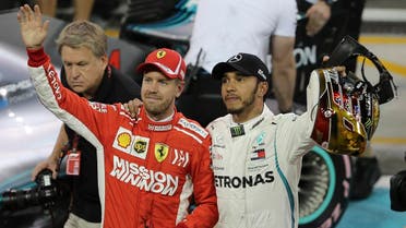 Mercedes driver Lewis Hamilton (right), and Ferrari driver Sebastian Vettel wave after the qualifying session at the Yas Marina racetrack in Abu Dhabi, UAE, on Saturday November 24, 2018.  (AP)