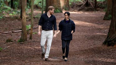 Britain's Prince Harry and Meghan, Duchess of Sussex walk through a Redwoods forest in Rotorua, New Zealand, Wednesday. (Reuters)