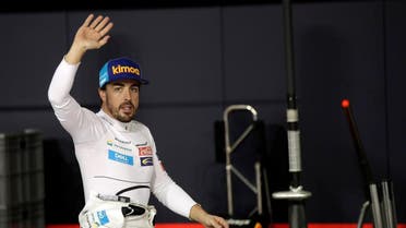 McLaren driver Fernando Alonso of Spain waves to spectators in the pit during the qualifying session at the Yas Marina racetrack in Abu Dhabi. (Reuters)