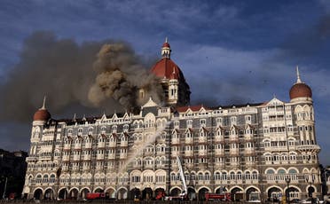In this file photo taken on November 27, 2008 Indian firefighters attempt to put out a fire as smoke billows from the Taj Mahal Palace hotel in Mumbai. (AFP)