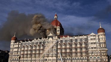 In this file photo taken on November 27, 2008 Indian firefighters attempt to put out a fire as smoke billows from the Taj Mahal Palace hotel in Mumbai. (AFP)