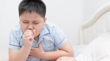 Sick obese boy is coughing and throat infection - Stock image