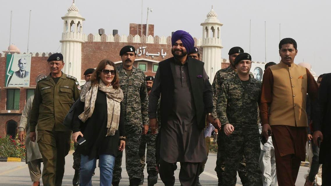 Former Indian cricketer-turned-politician Navjot Singh Sidhu, (center), arrives at the Pakistani border post Wagha near Lahore, Pakistan, on November 27, 2018. (AP)
