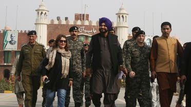 Former Indian cricketer-turned-politician Navjot Singh Sidhu, (center), arrives at the Pakistani border post Wagha near Lahore, Pakistan, on November 27, 2018.  (AP)
