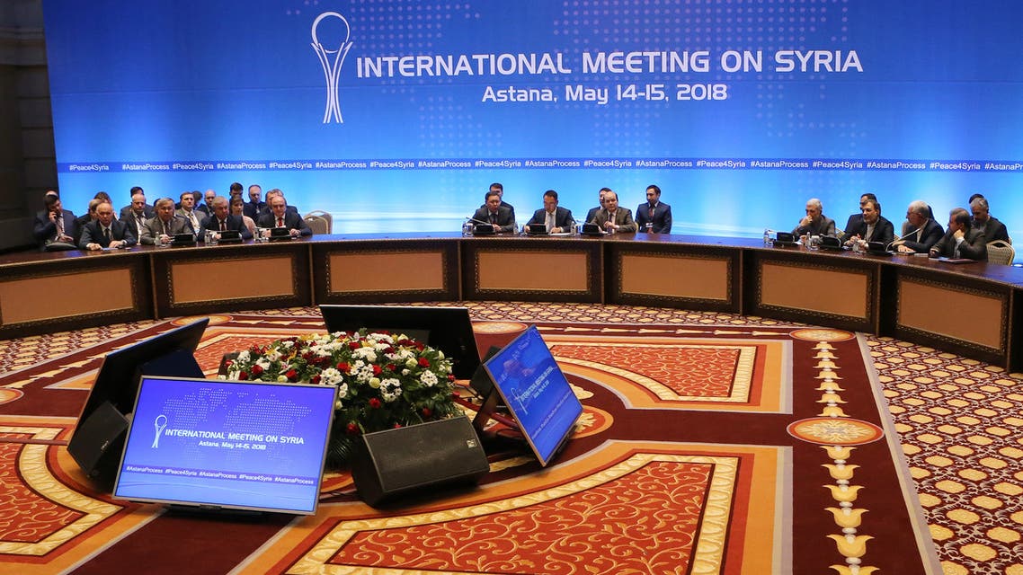 A general view of shows Syrian regime representatives, opposition delegates and other attendees as they take part in the plenary session of Syria peace talks brokered by Iran, Russia and Turkey in Astana on May 15, 2018.