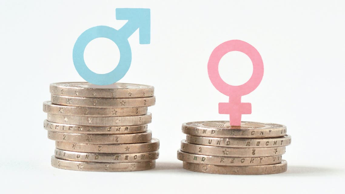 Male and female symbols on piles of coins - Gender pay equality concept - Stock image