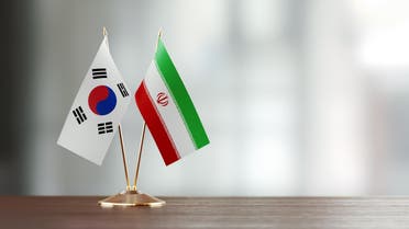South Korean and Iranian flag pair on a desk. (Stock image)