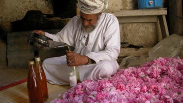 An Omani farmer working at his traditional rose distillation unit. (Supplied)