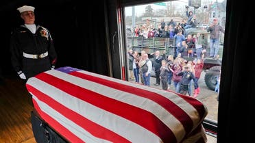 The flag-draped casket of former President George H.W. Bush passes through Magnolia, Texas, Thursday, Dec. 6, 2018, along the route from Spring to College Station, Texas. (AP)