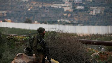 FILE PHOTO: FILE PHOTO: An Israeli soldier guards near the border with Lebanon, the morning after the Israeli military said it had launched an operation to "expose and thwart" cross-border attack tunnels from Lebanon, in Israel's northernmost town Metula December 5, 2018. REUTERS/Ronen Zvulun/File Photo/File Photo