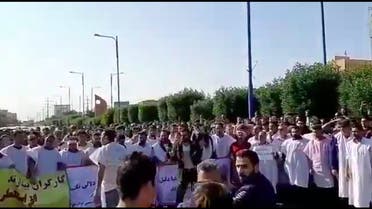 Iranian workers dressed in burial clothes protest, chant against the regime