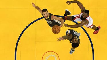 James Harden #13 of the Houston Rockets takes a shot over Stephen Curry #30 and Jordan Bell #2 of the Golden State Warriors during Game Four of the Western Conference Finals of the 2018 NBA Playoffs. (AFP)