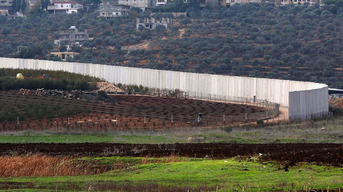A picture taken on December 4, 2018 from a position near the southern Lebanese village of Kfar Kila shows a section of the concrete border wall between Lebanon (R) and Israel. (AFP)